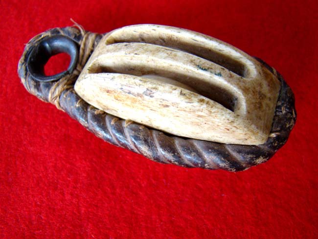 A carved whalebone double block with leather covered rope and brass grommet circa 1850-1870 — image 3